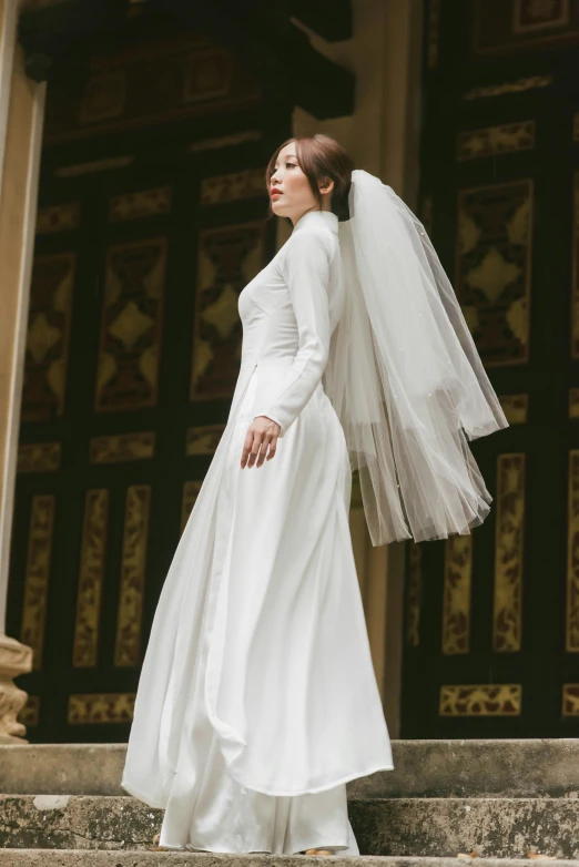 a woman wearing a veil standing on steps