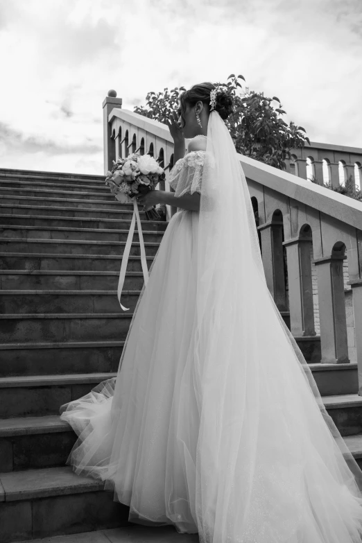 bride and groom standing on stairs