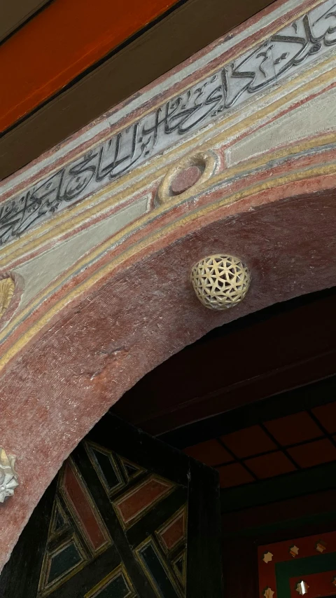 ornate details painted on an arch with a clock