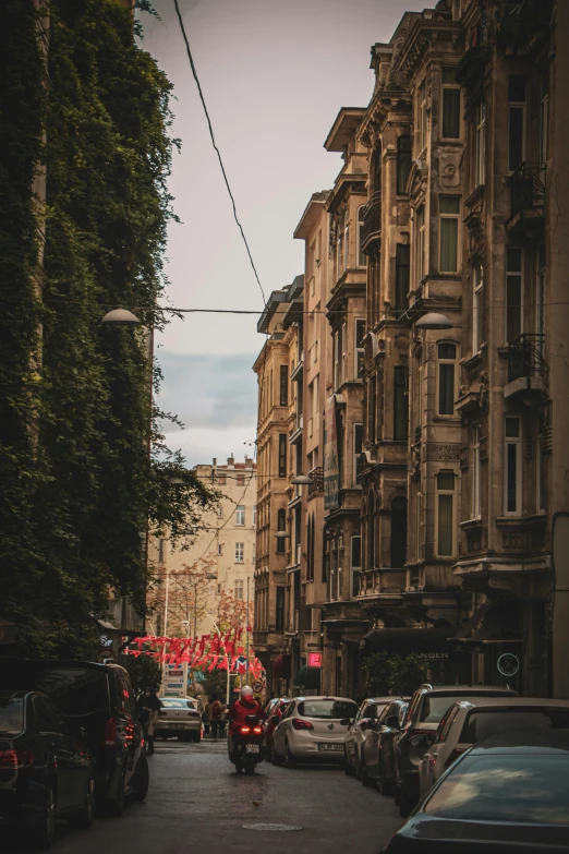 cars are parked along the side of a busy street