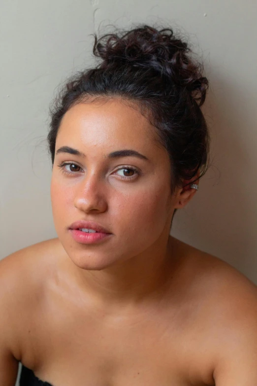 a woman with dark hair looks at the camera