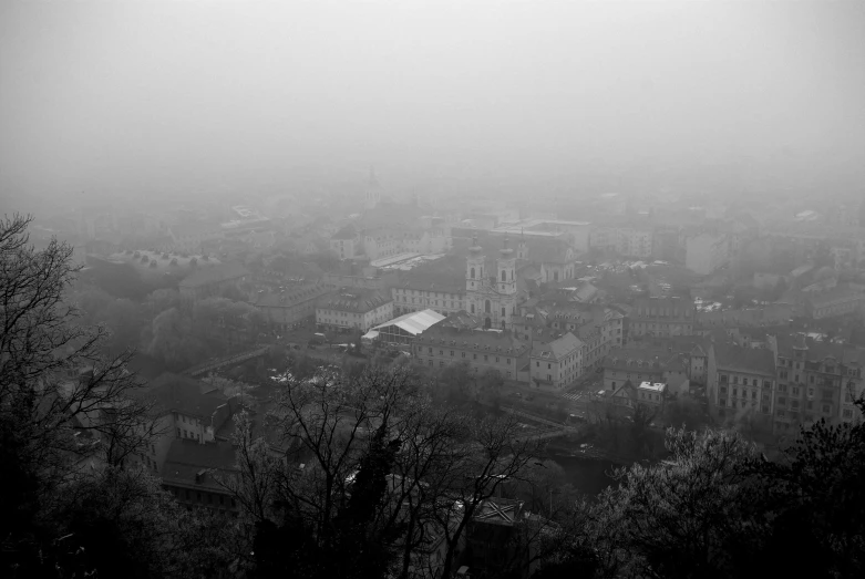 a black and white po of buildings on a foggy day