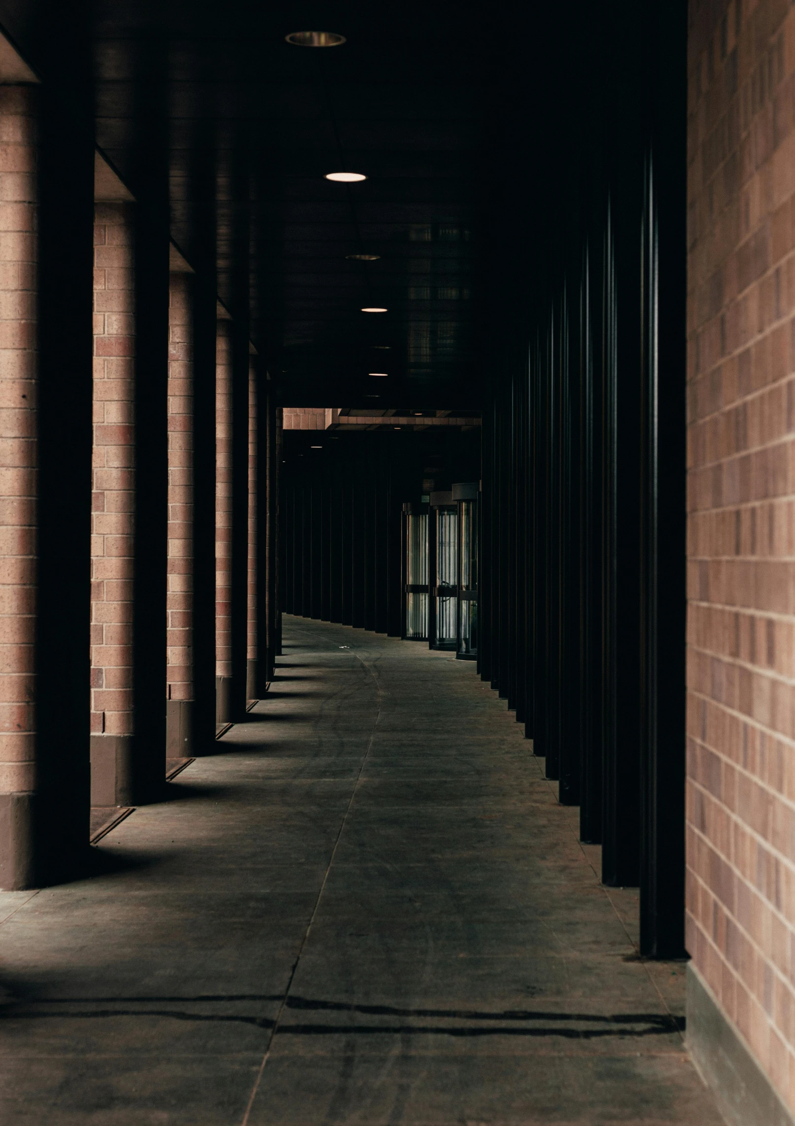 the dark corridor leading to the doors of the building