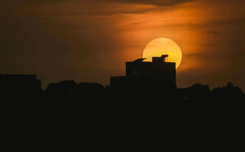 a view of the sun peeking from behind the clouds