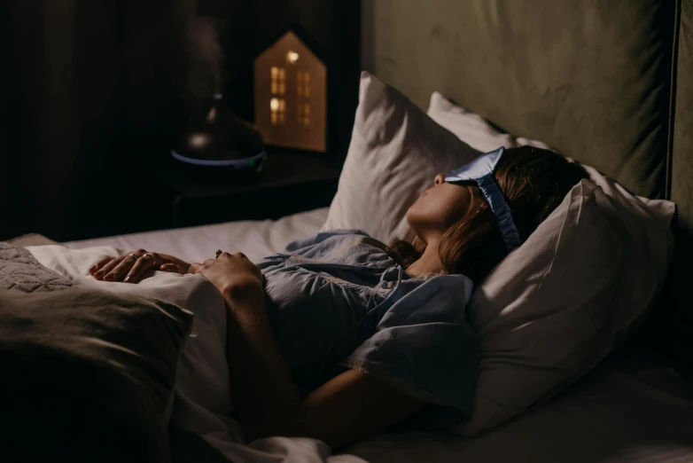 a woman sleeping on top of her bed