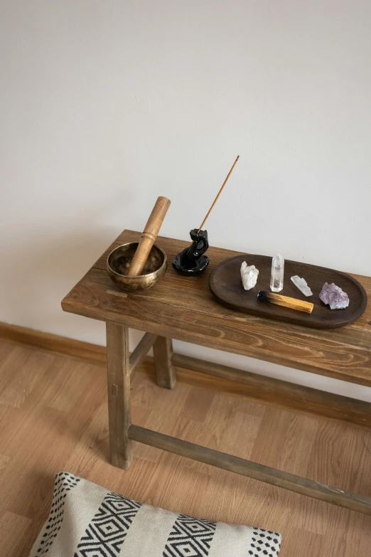 wooden bench with art items placed on top