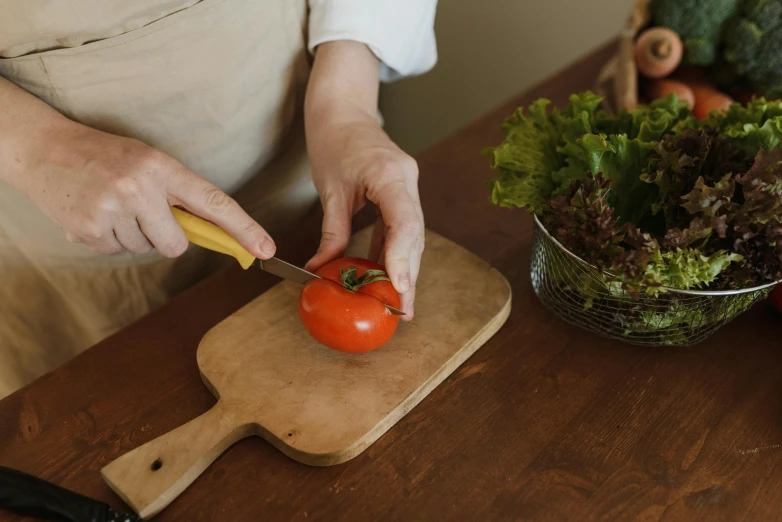 there is a woman  vegetables on the counter