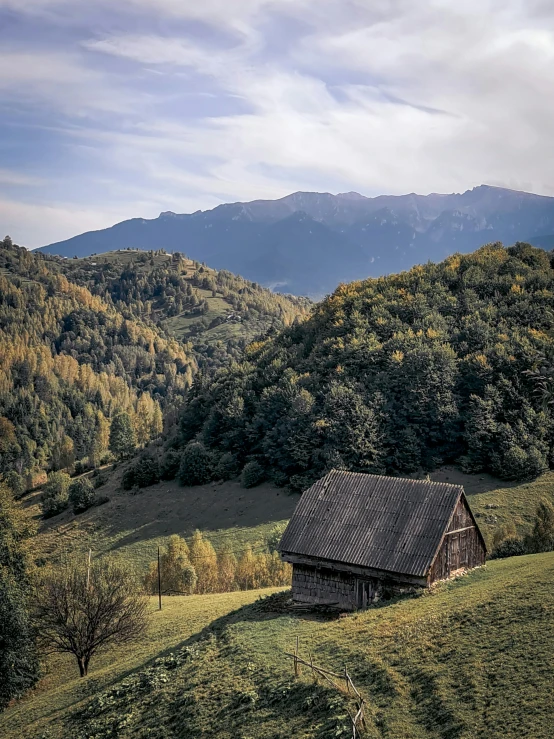 a mountain range has a cabin built into the hillside