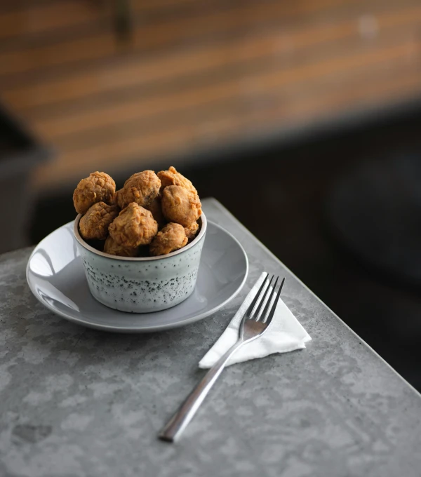 small plate with donuts and silverware on table