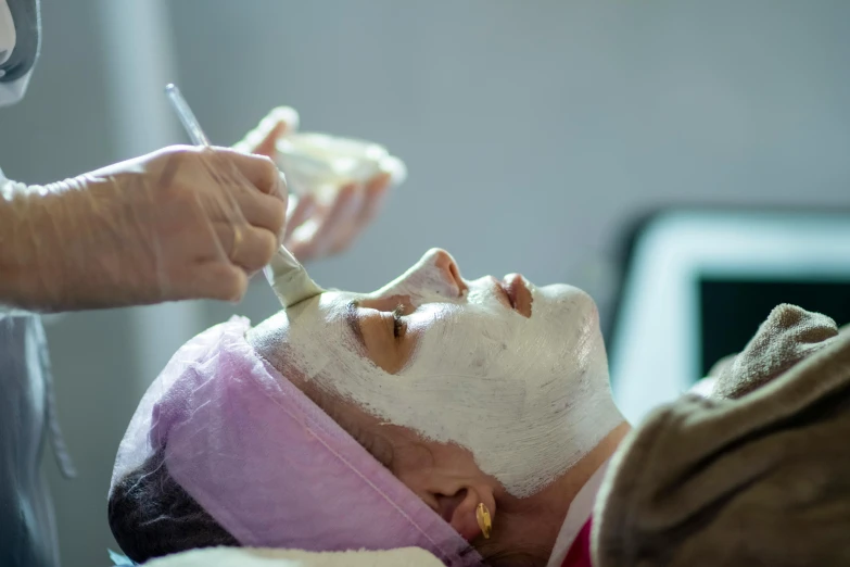 a person getting facial mask made from a man