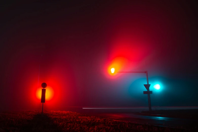 an eerie night with traffic lights in the foreground