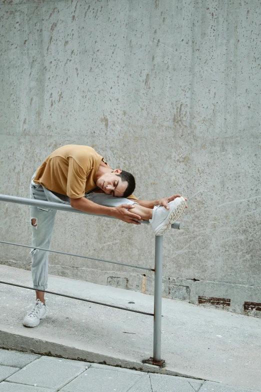 a man standing on a ledge next to a white wall