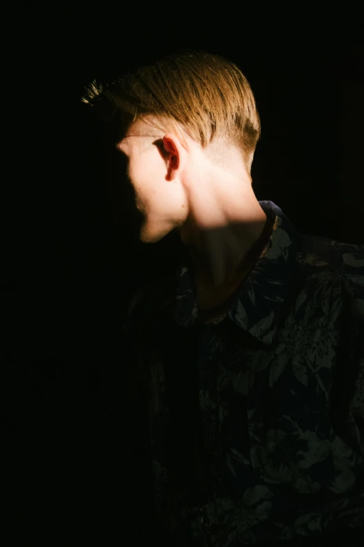 a close up of a person with his ear lit by the flashlight