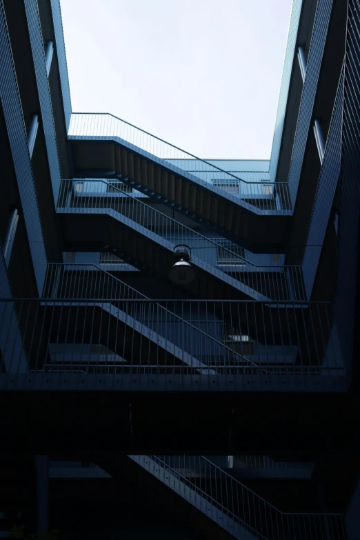 some people walking down some stairs while the sky is blue