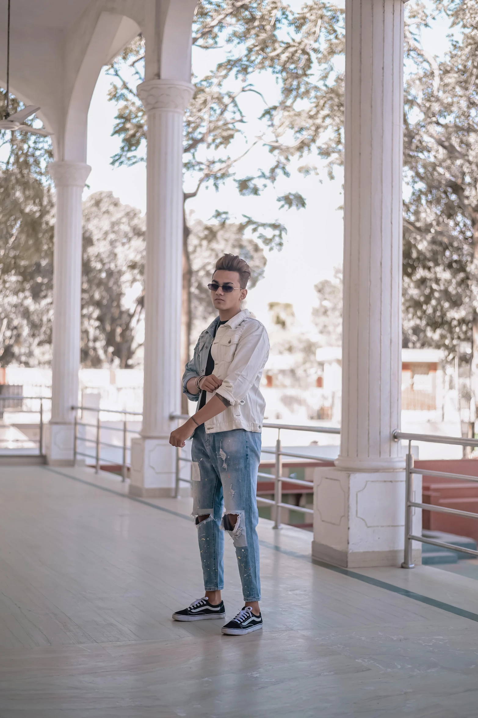 a man with sunglasses is standing on the ground