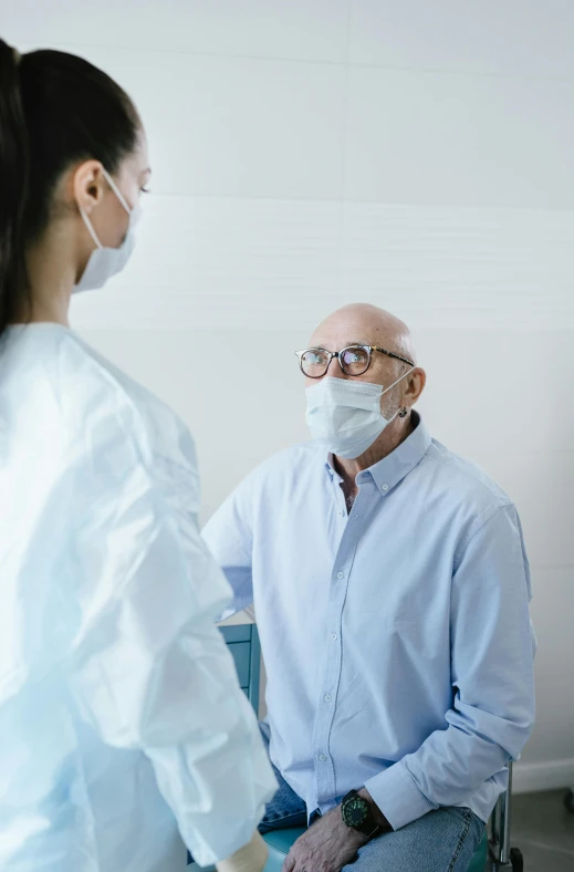 a woman with glasses and a man in medical mask