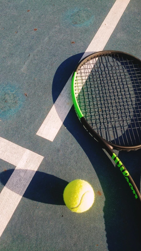 tennis racket and a ball on the court