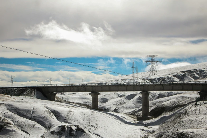 there is a snow covered mountain with tracks on the side