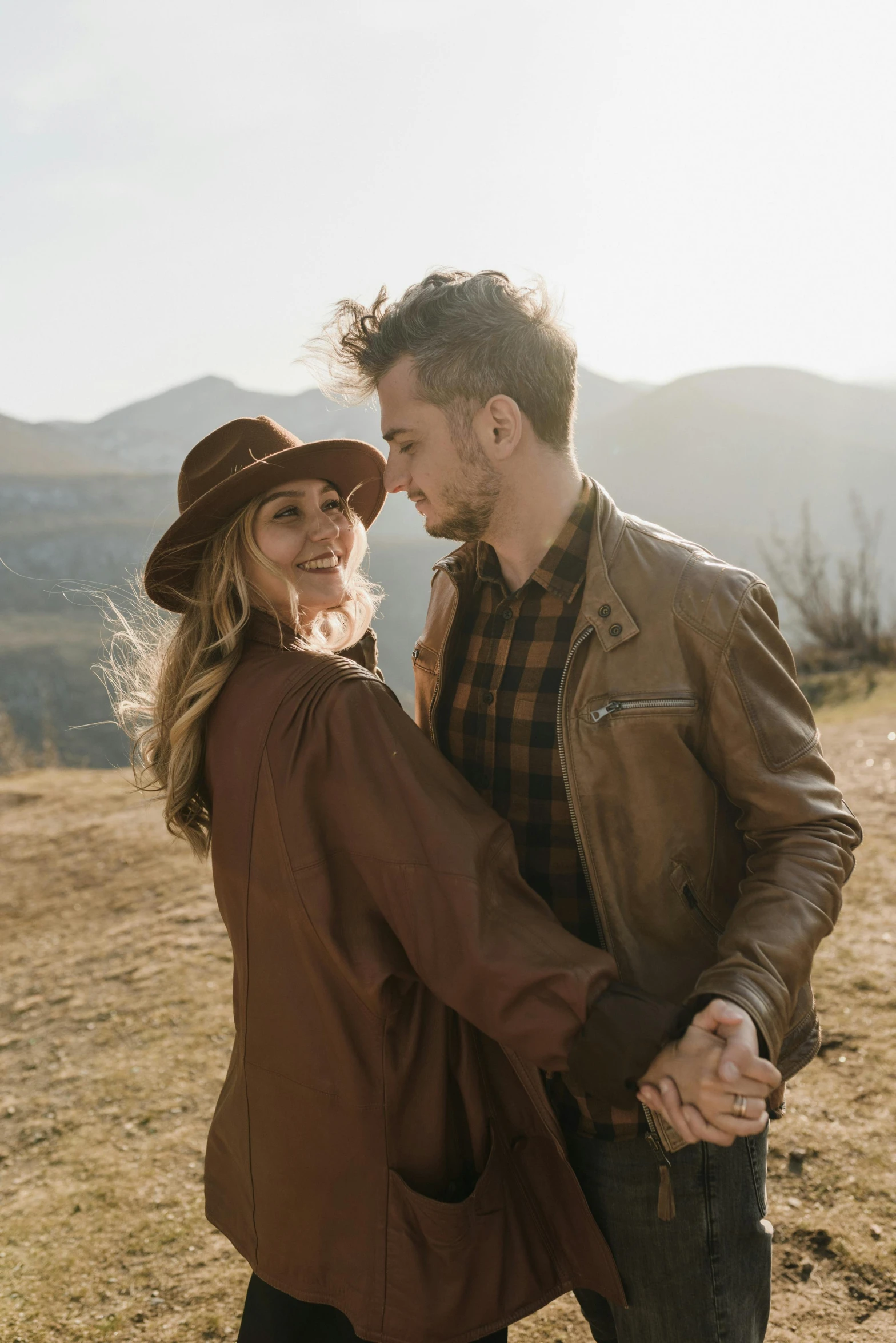 a man and woman holding hands standing together