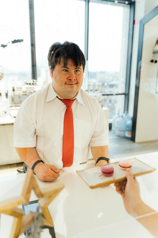 a man with an orange tie sits at a table