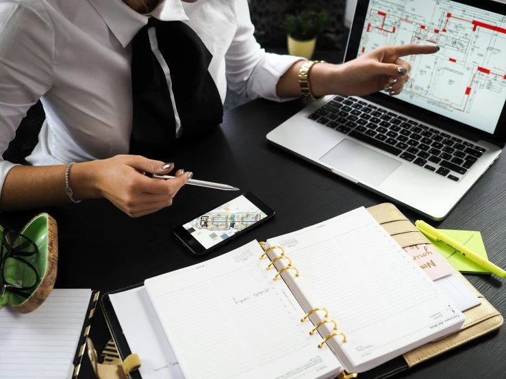 a person that is looking at some documents on a table