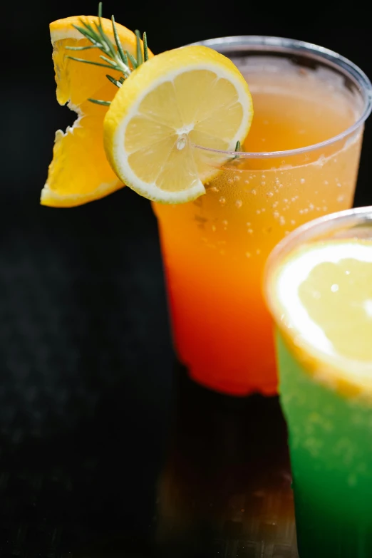 a close up of two cups on a table with drinks in them