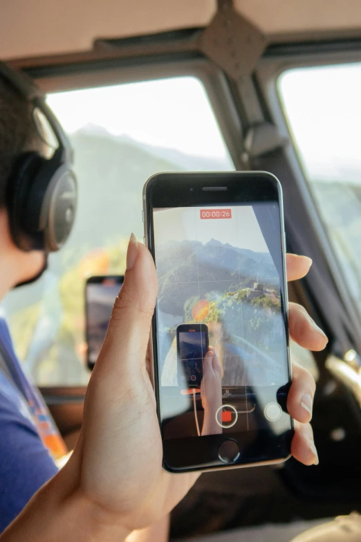 a person sitting inside of an airplane while using a phone