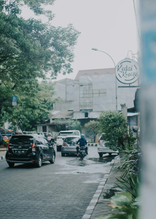 cars, trucks and motorcycles stopped at an intersection