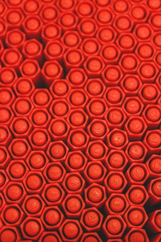 an up close view of many red objects that look like rubber disks