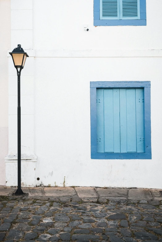 a street lamp next to a white building