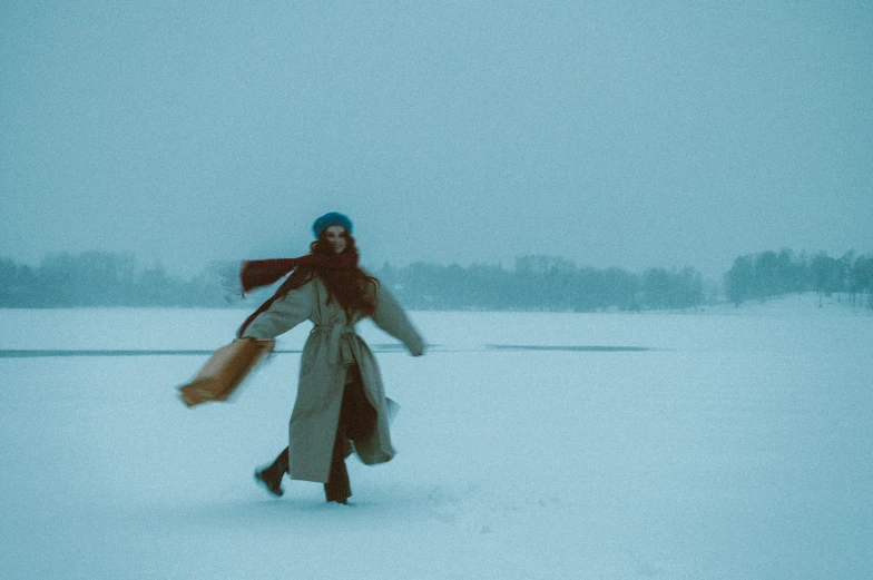 a woman with a hat is in the snow