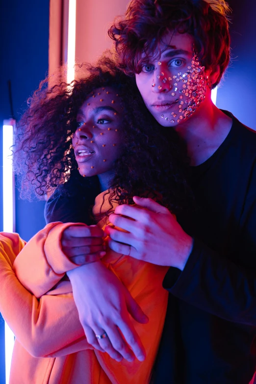 two people in front of a purple light