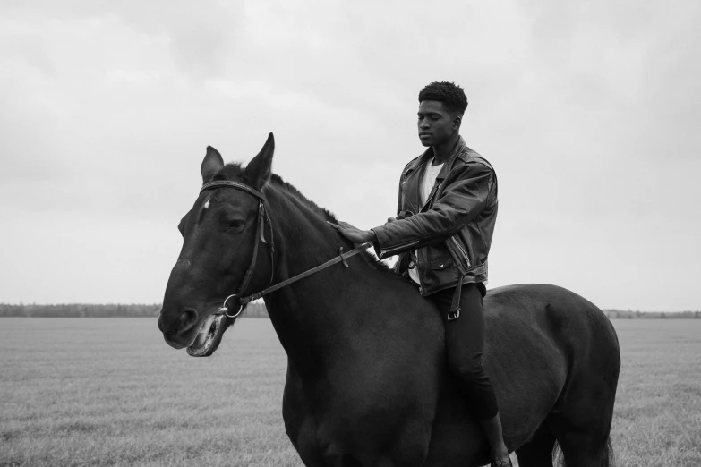 a man rides his horse through a field