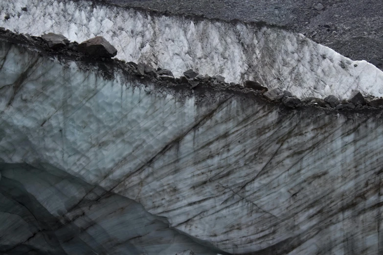 close up s of white and grey rocks with water on the side