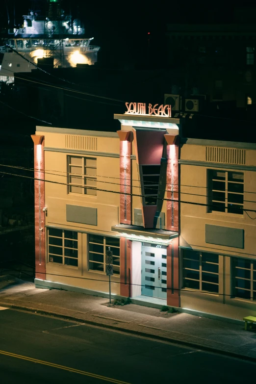 a night view of the front and side of a building