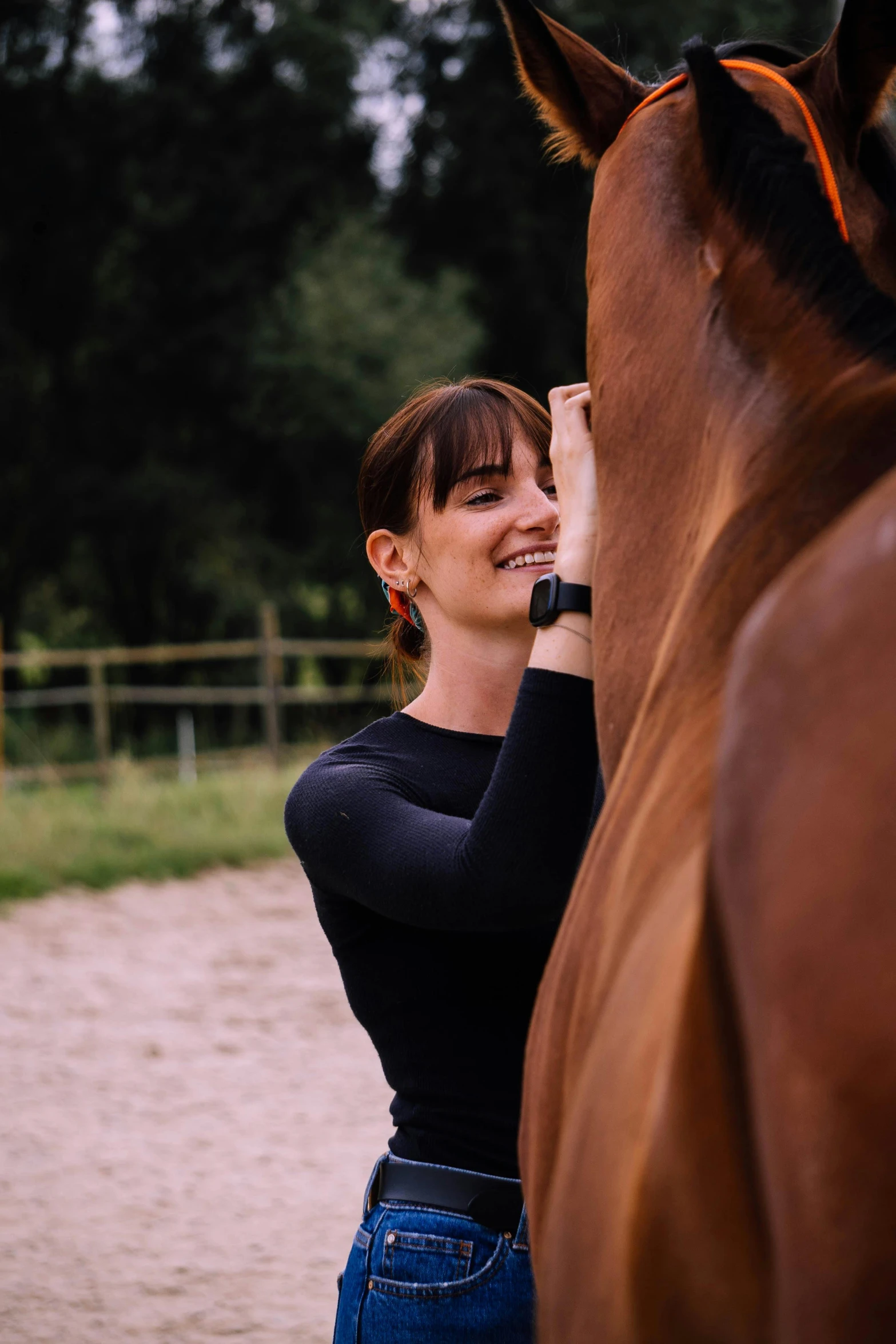 a young lady is petting a horse outside