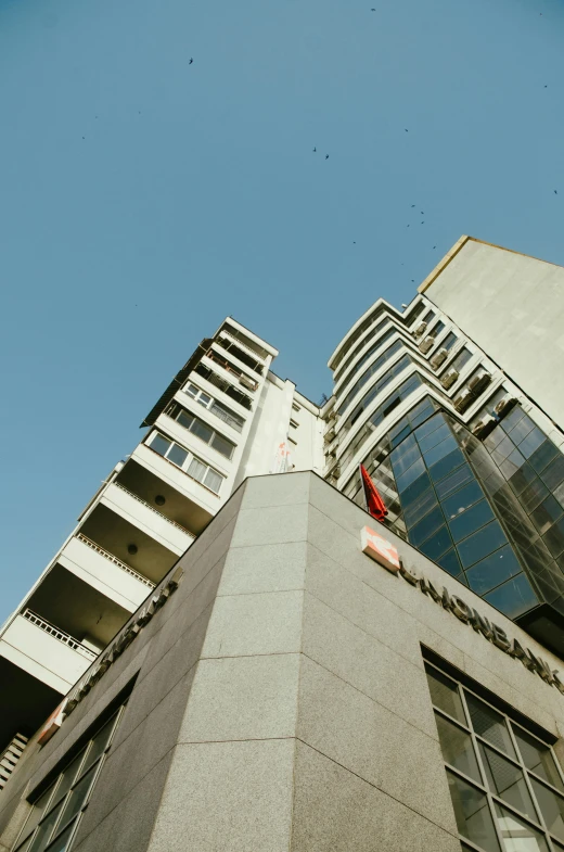 a tall building next to two other buildings