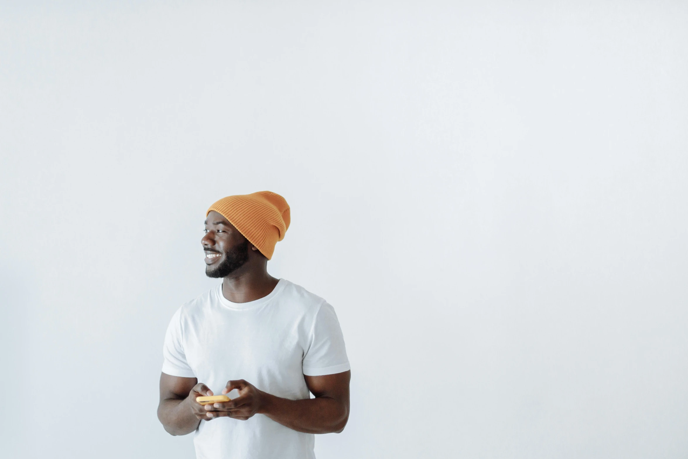 a man wearing an orange turban holding a banana