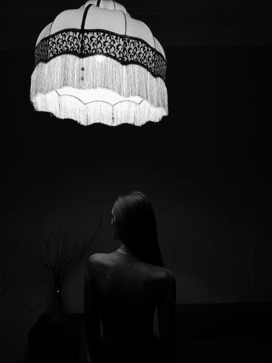 a person sitting down under a ceiling light