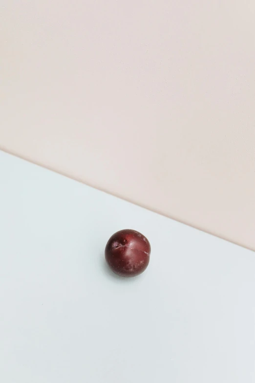 an apple sitting on top of a white table