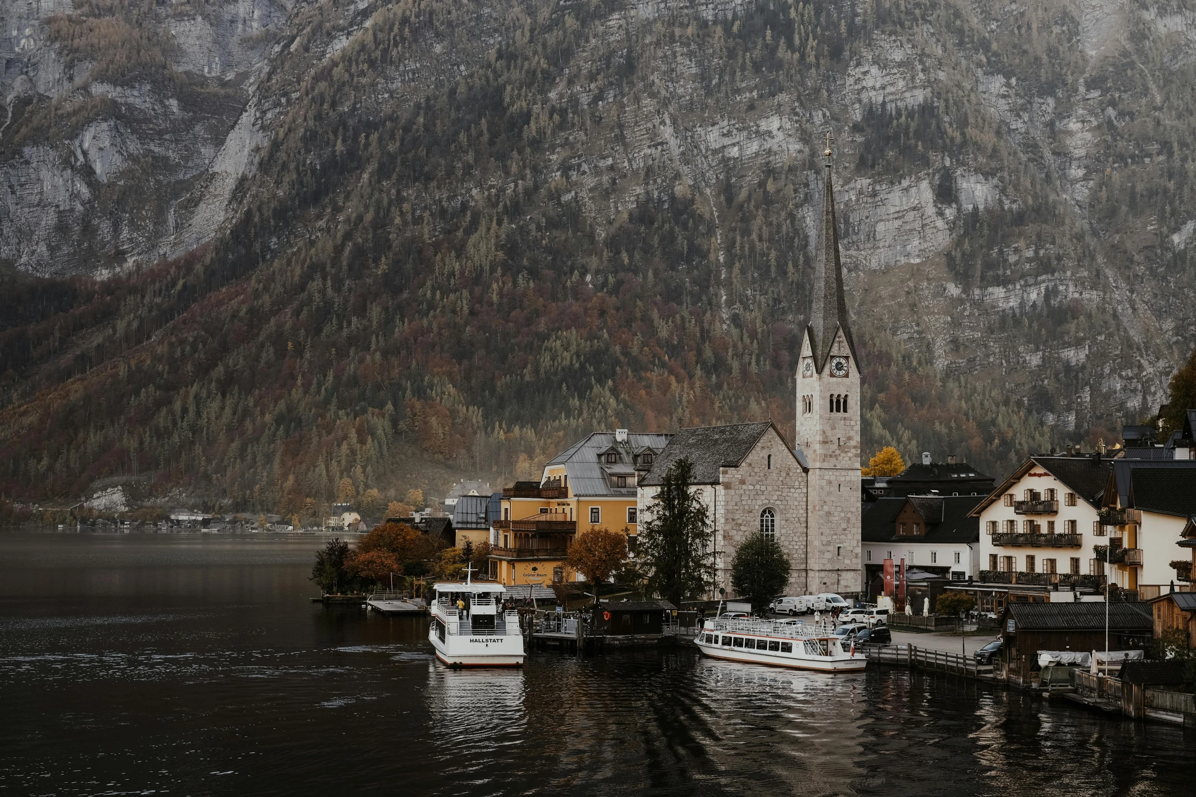 two boats floating in front of a very pretty village