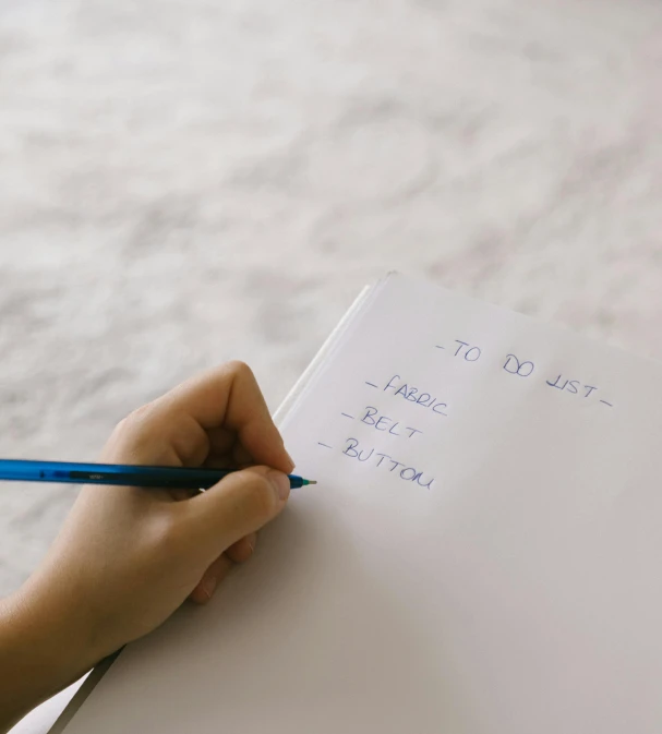 a person writing soing on a piece of paper