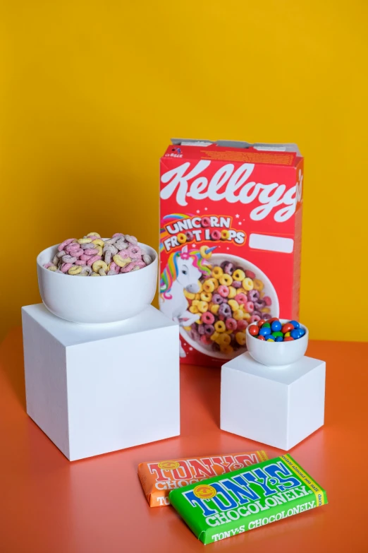 cereal is in a bowl and cereal is near a box of cereal