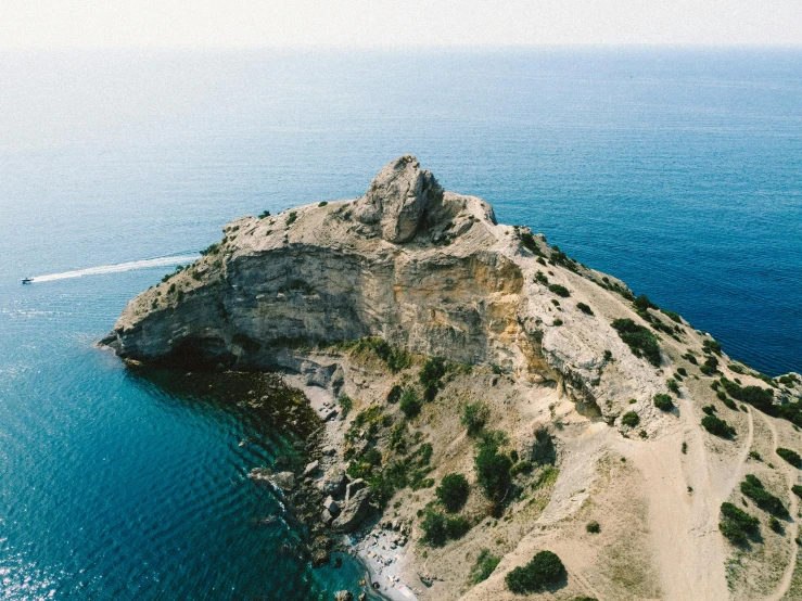 an island off the coast is shown from above