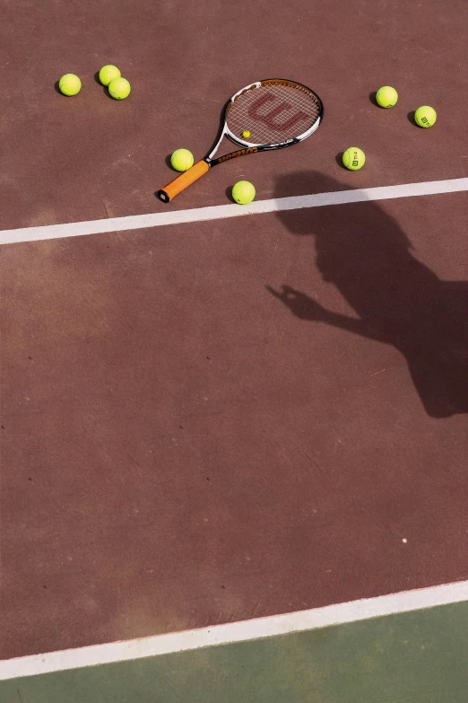 a tennis player is hitting some balls with his racquet