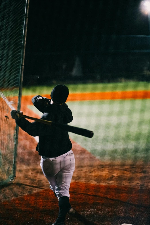 man holding a baseball bat in front of the catcher