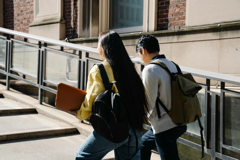 two people with backpacks going down the steps