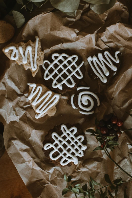 four cut out cookies sit on brown paper