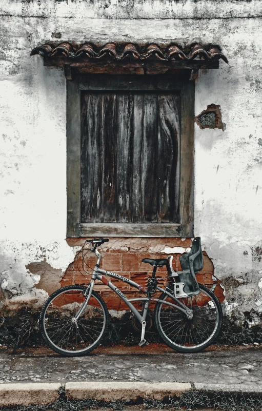 a pair of bikes sitting next to a window