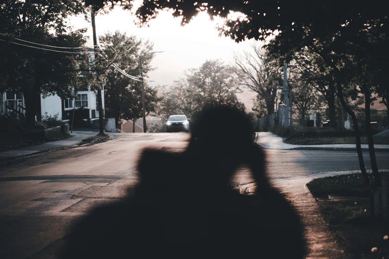 the shadow of a person on a motorcycle on the street